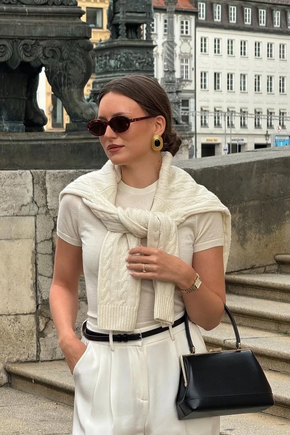 Cream t-shirt with cable sweater and white trousers