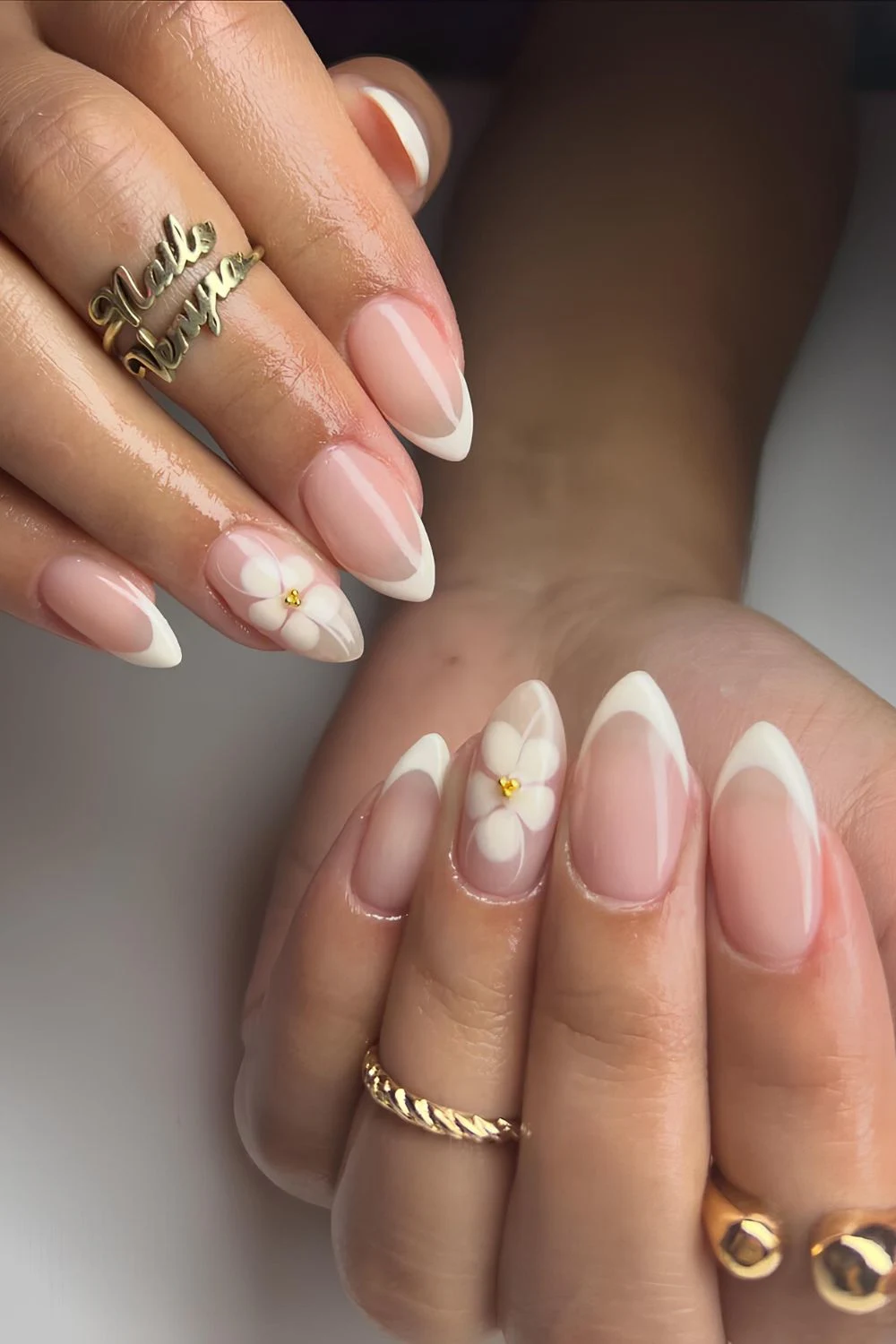 Creamy white French almond Nails with blooming flower accent