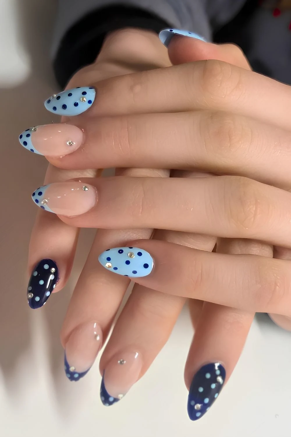 Dark and light blue nails with dots and rhinestones