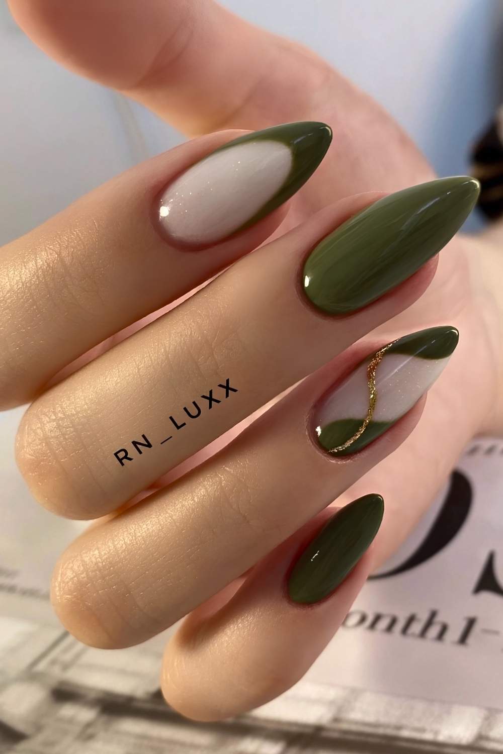 Dark olive and white nails with gold glitter