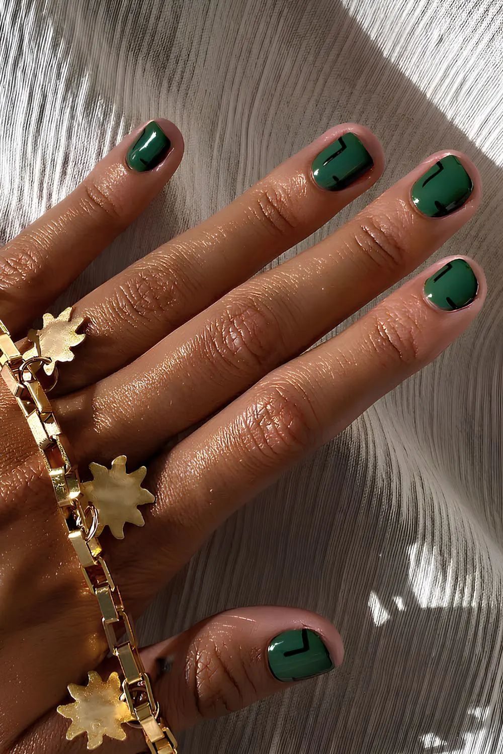 Emerald green nails with geometric art