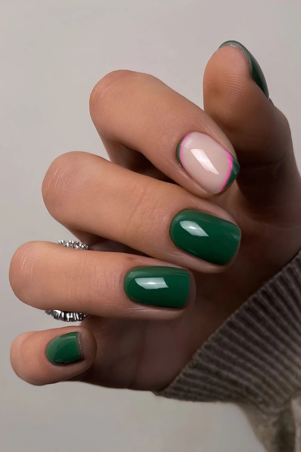 Emerald green nails with pink accents