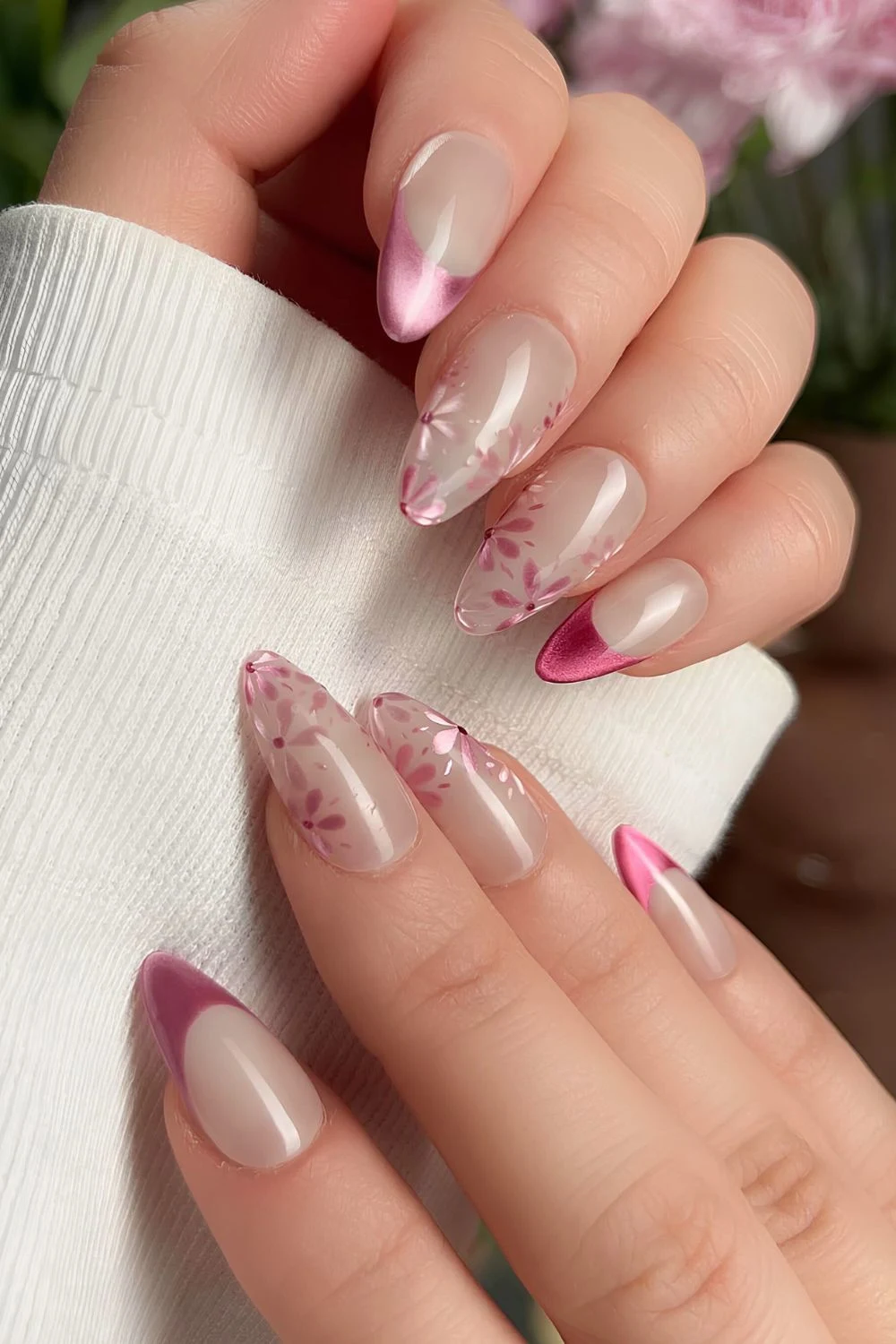 Glossy milky nails with pink cat-eye effect and florals