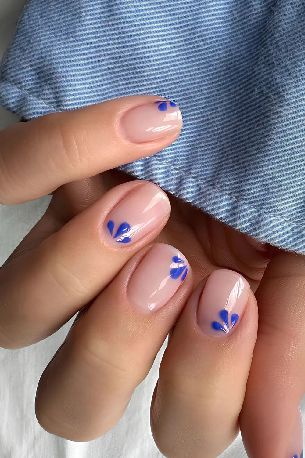 Glossy sheer nails with blue floral art