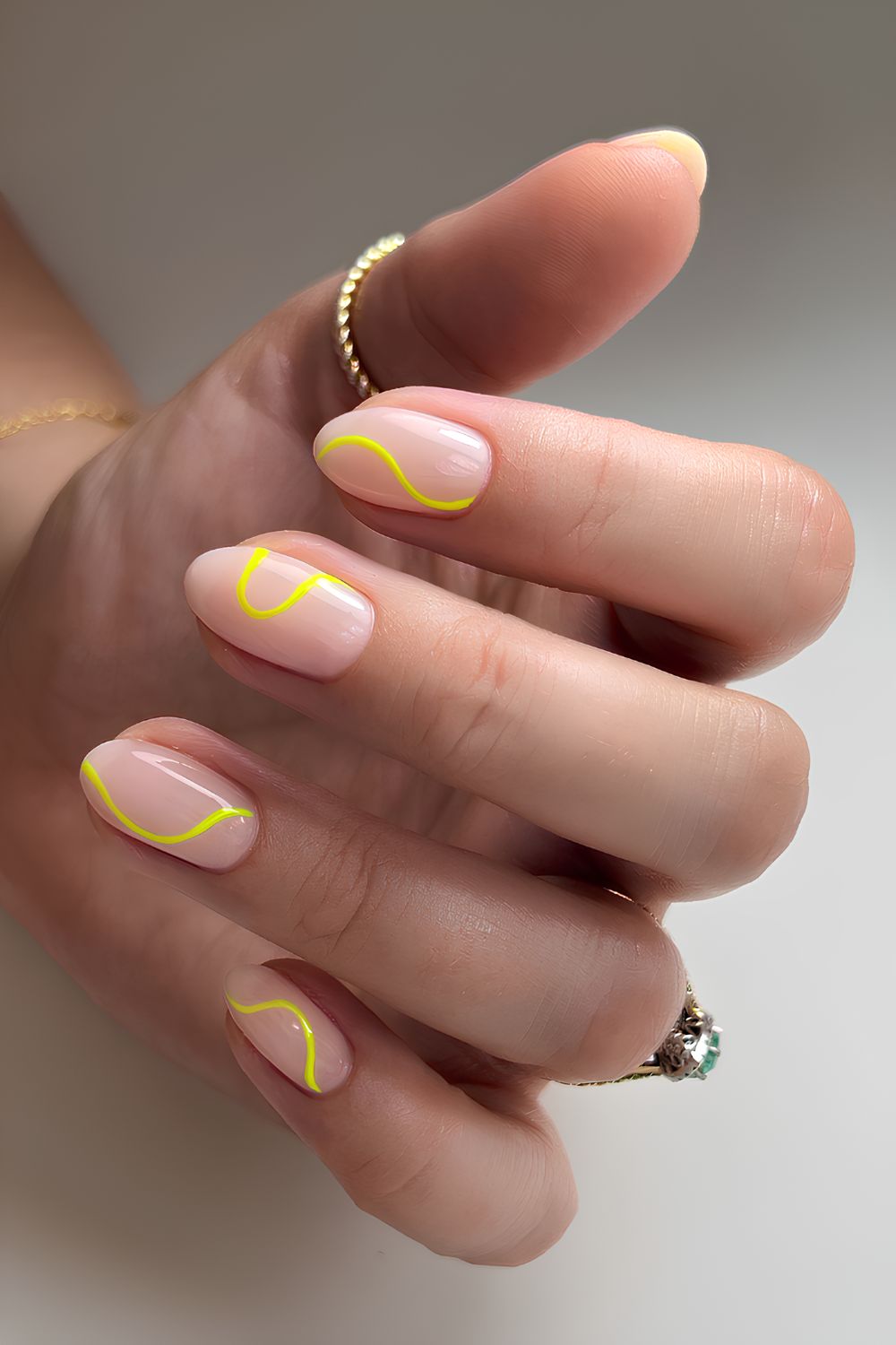 Glossy sheer nails with yellow line art