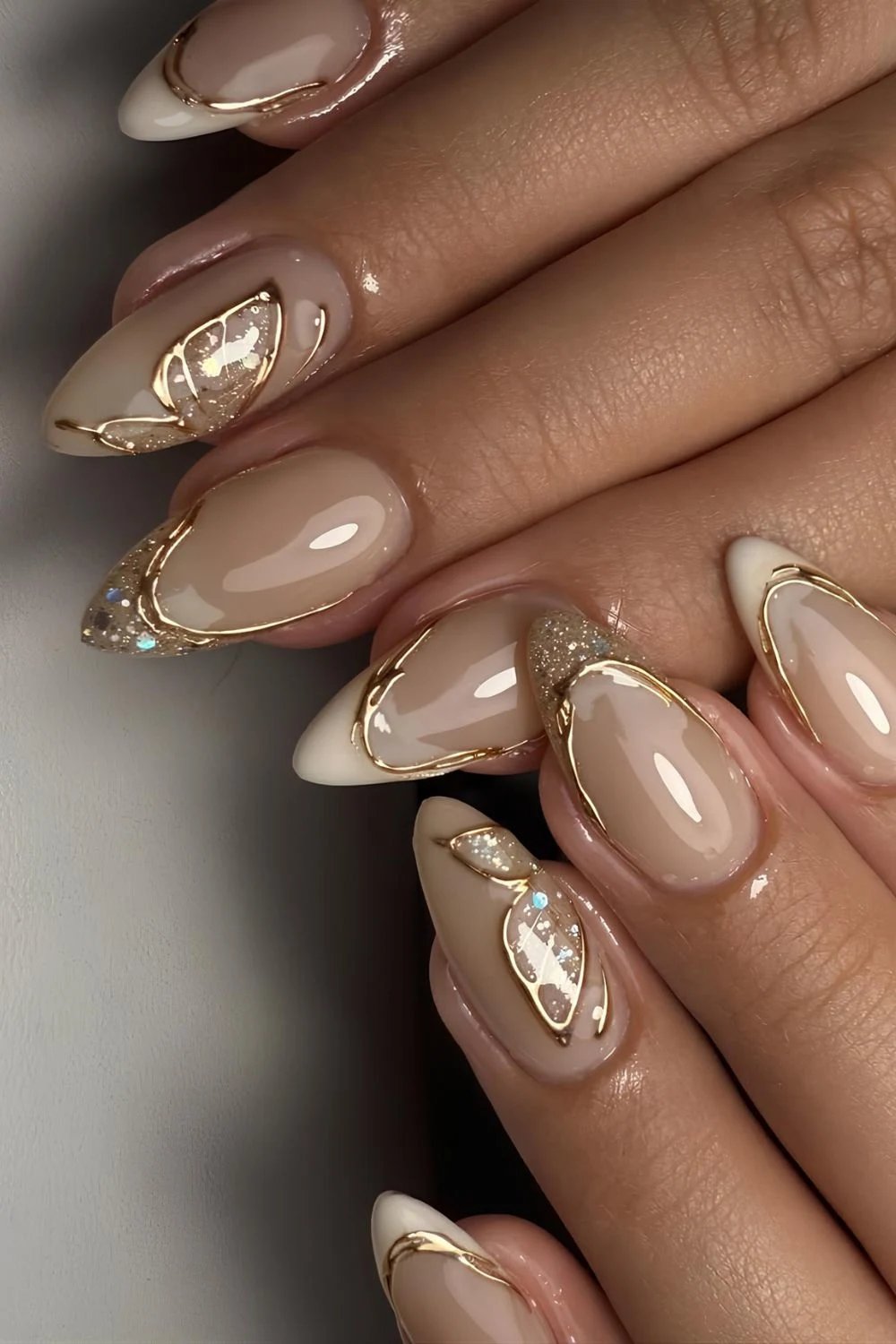 Glowy beige French mani with gold chrome accents