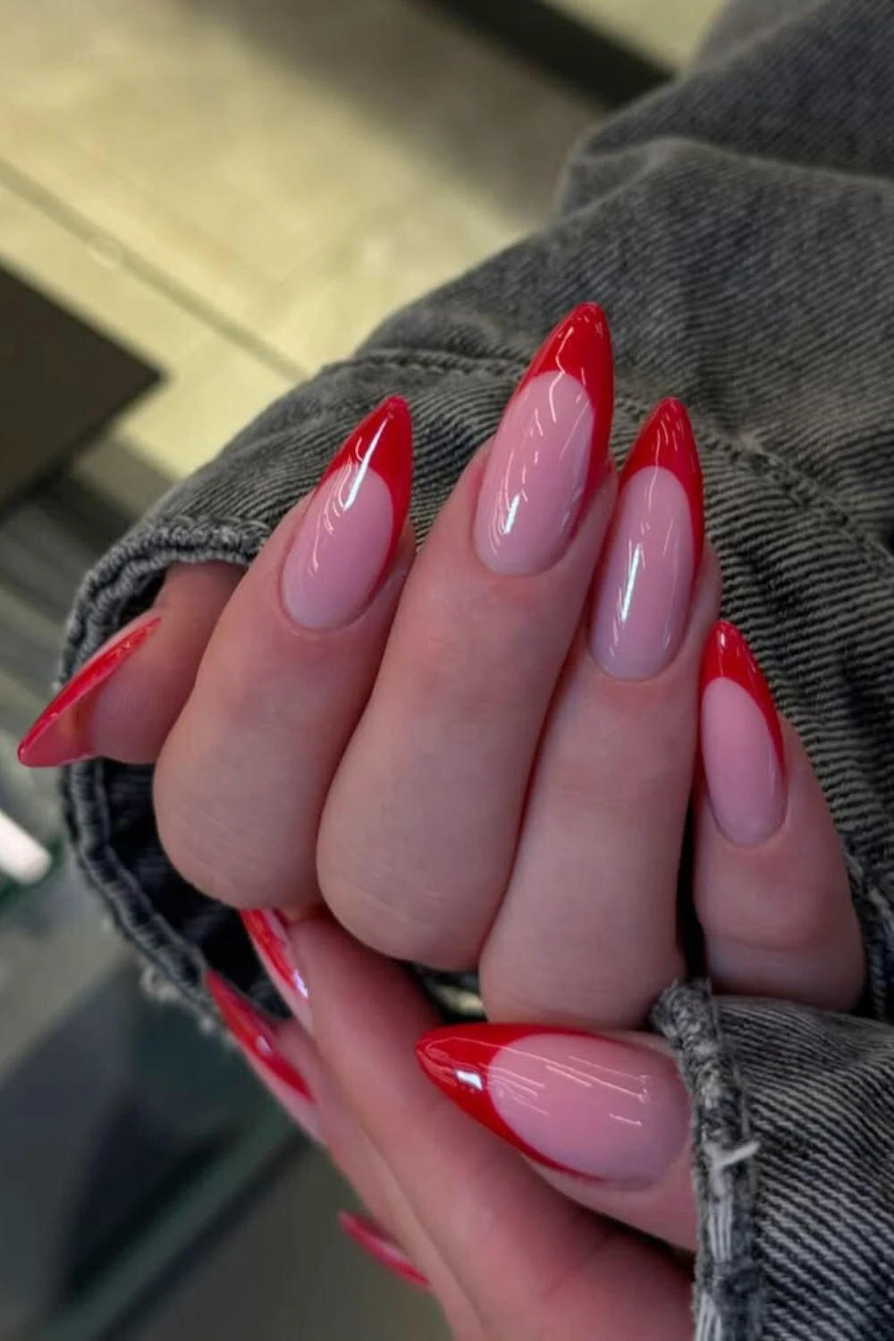 Glowy red French nails with sheer pink base