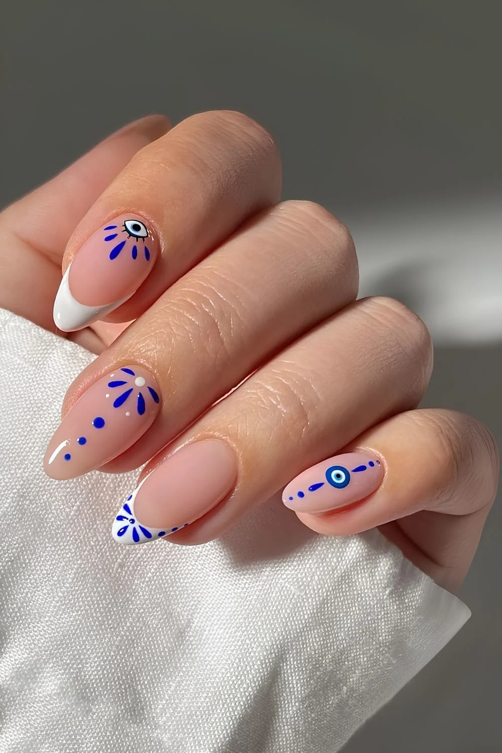Greek aesthetic-inspired nail art with evil eye details