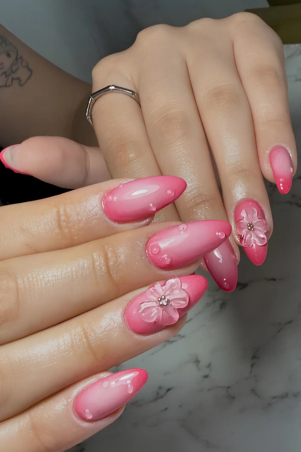 Hot pink aura nails with textured flowers