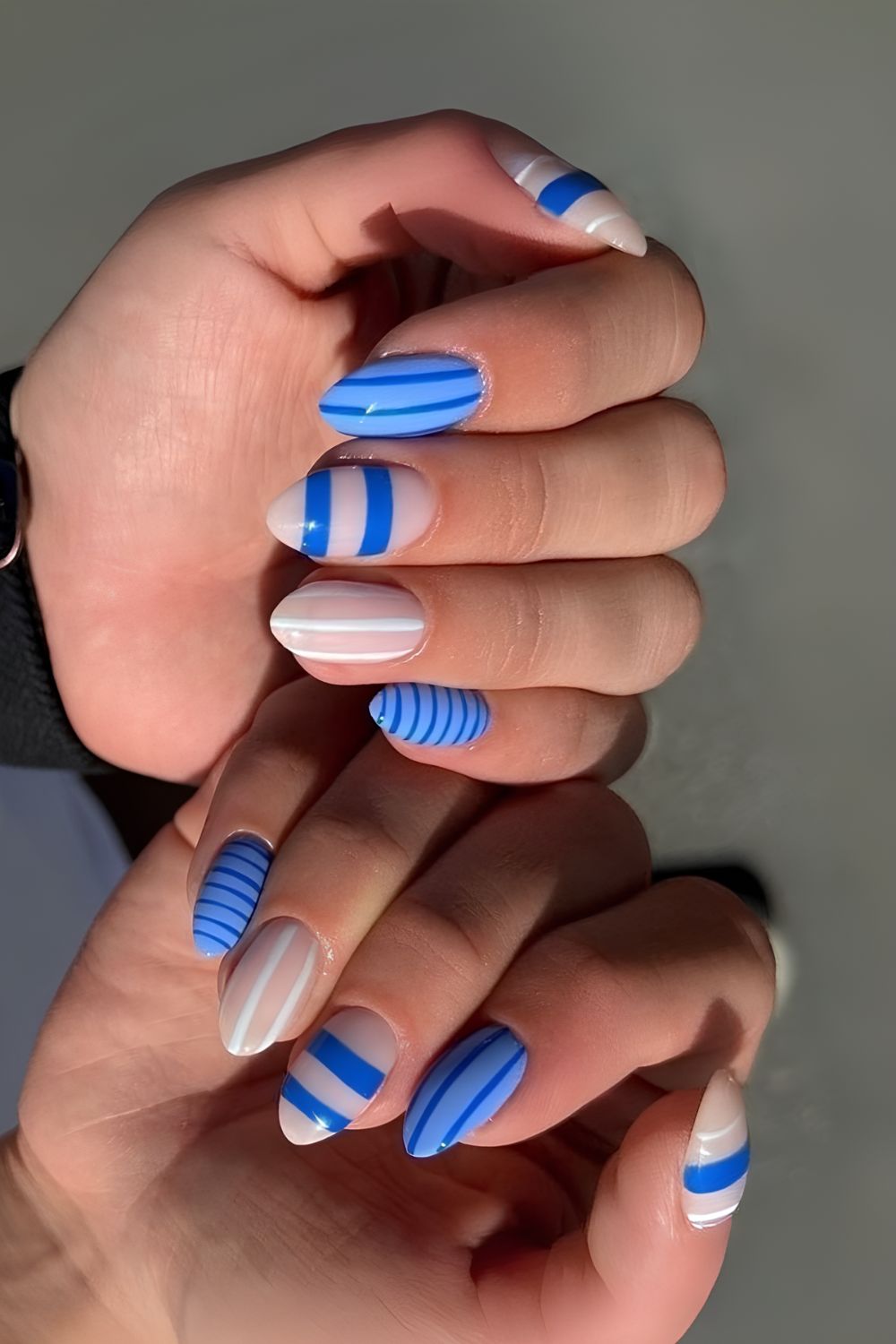 Light blue and white stripes nails with dot and floral details