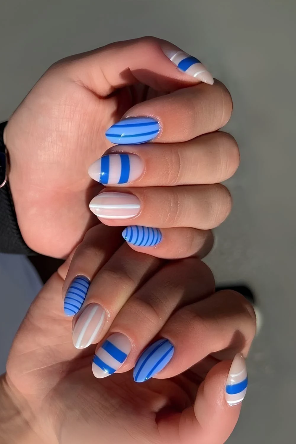 Light blue and white stripes nails with dot and floral details