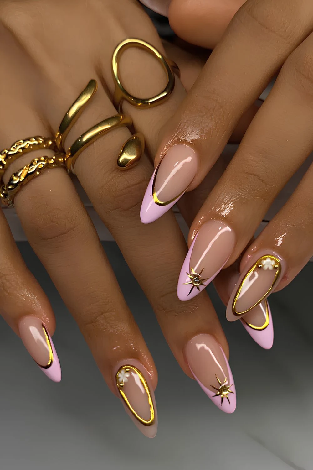 Light pink French nails with gold chrome details