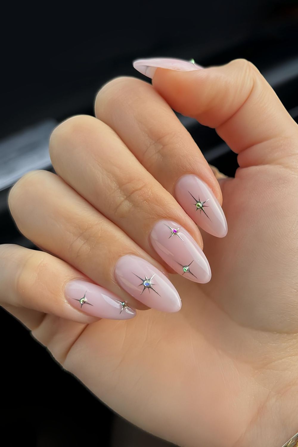 Light pink mani with celestial charms