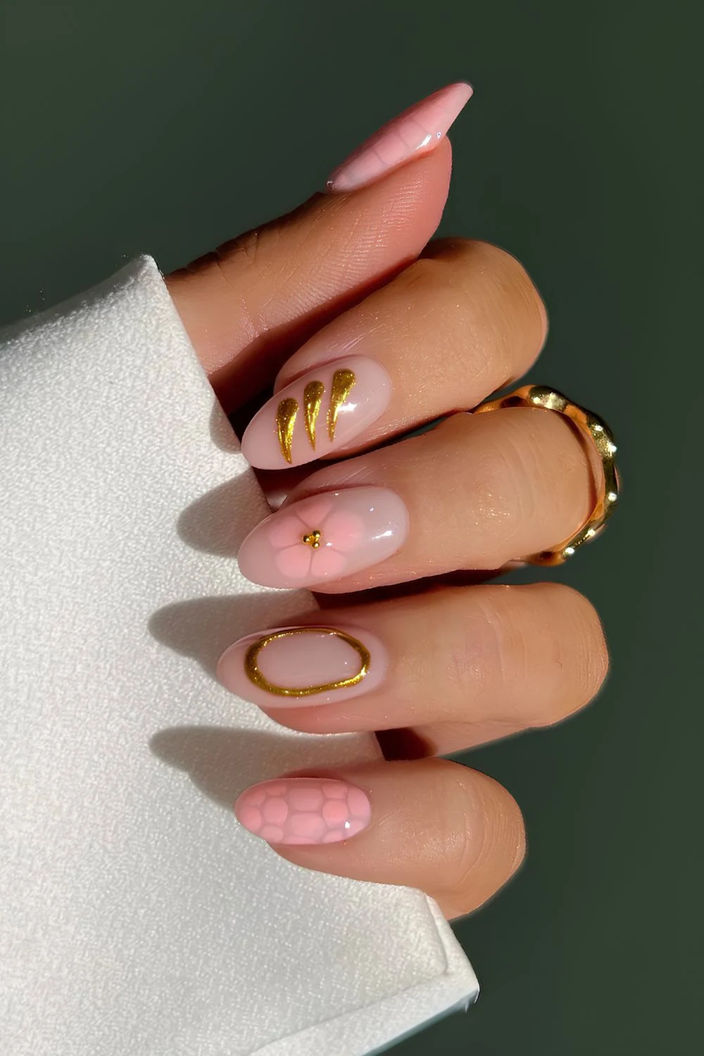 Light pink mix and match nails with flowers and gold details