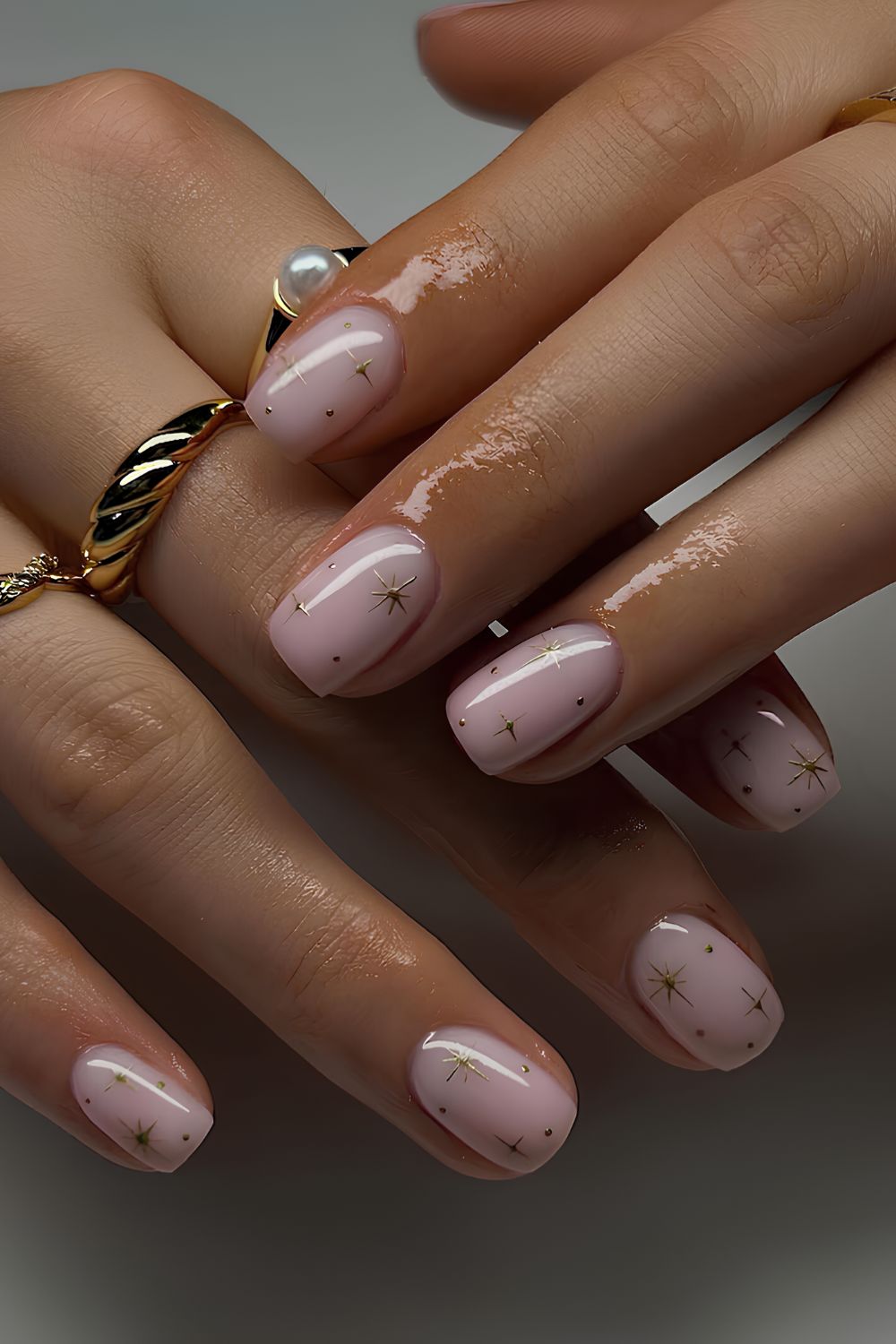 Light pink nails with tiny chrome stars