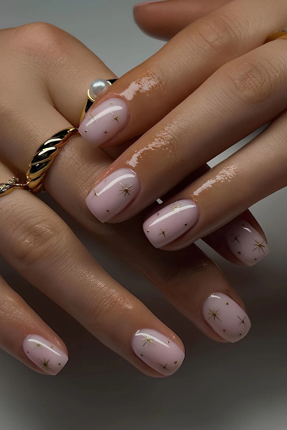 Light pink nails with tiny chrome stars