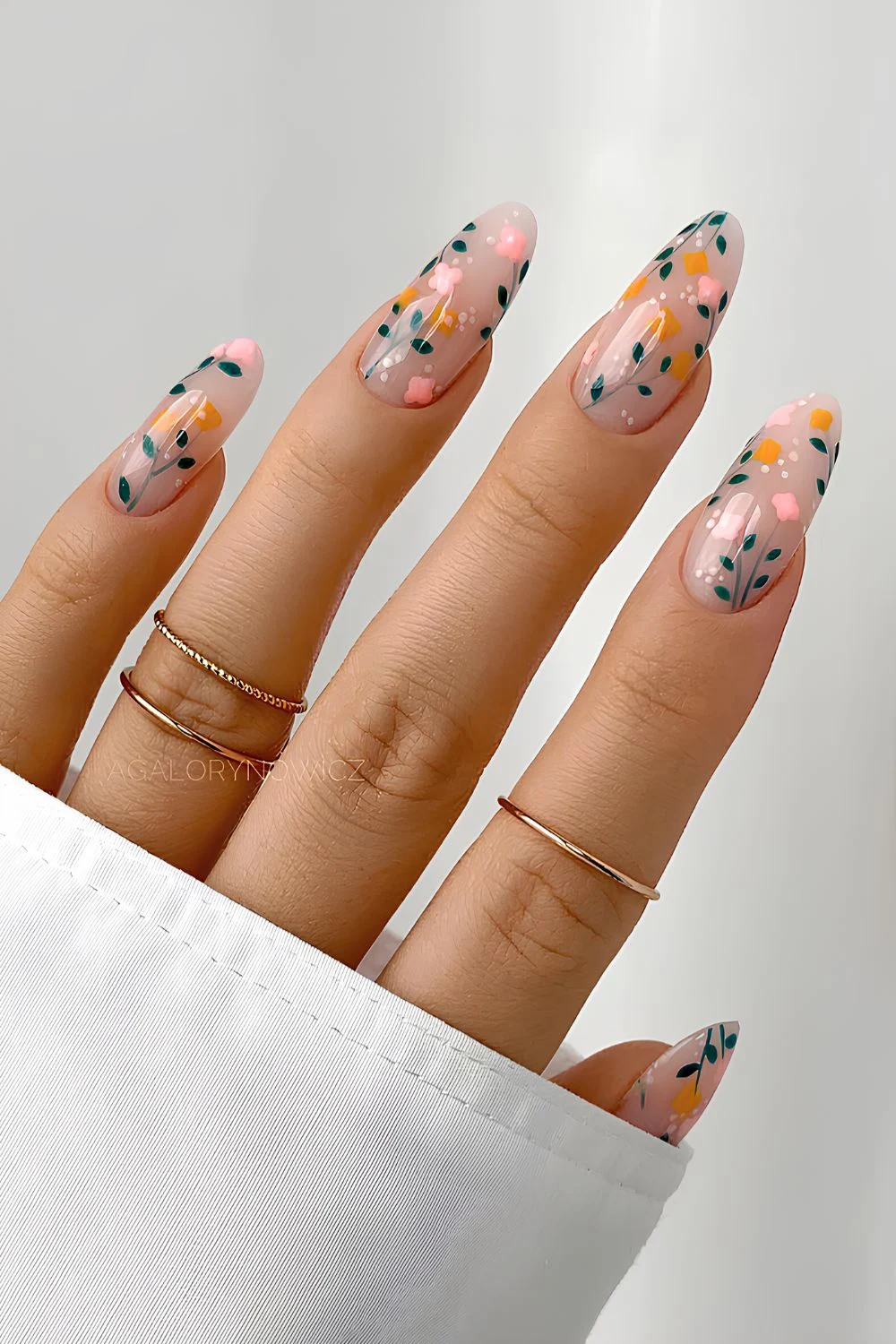 Milky mani with floral accents in orange and pink with greens