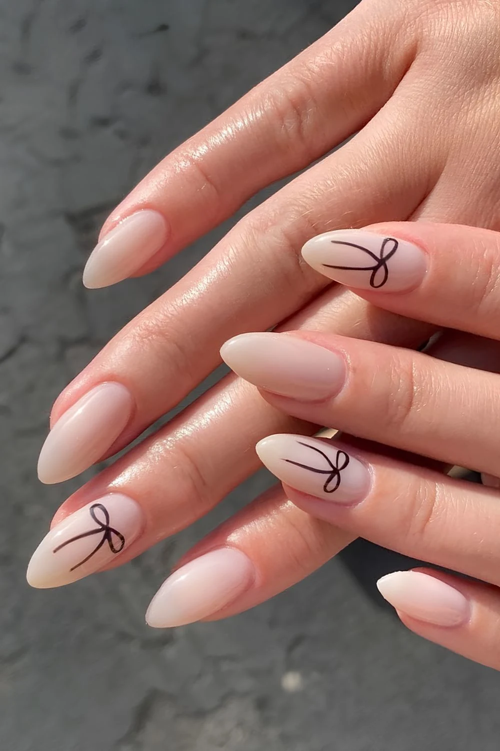 Milky nails with black bow accents
