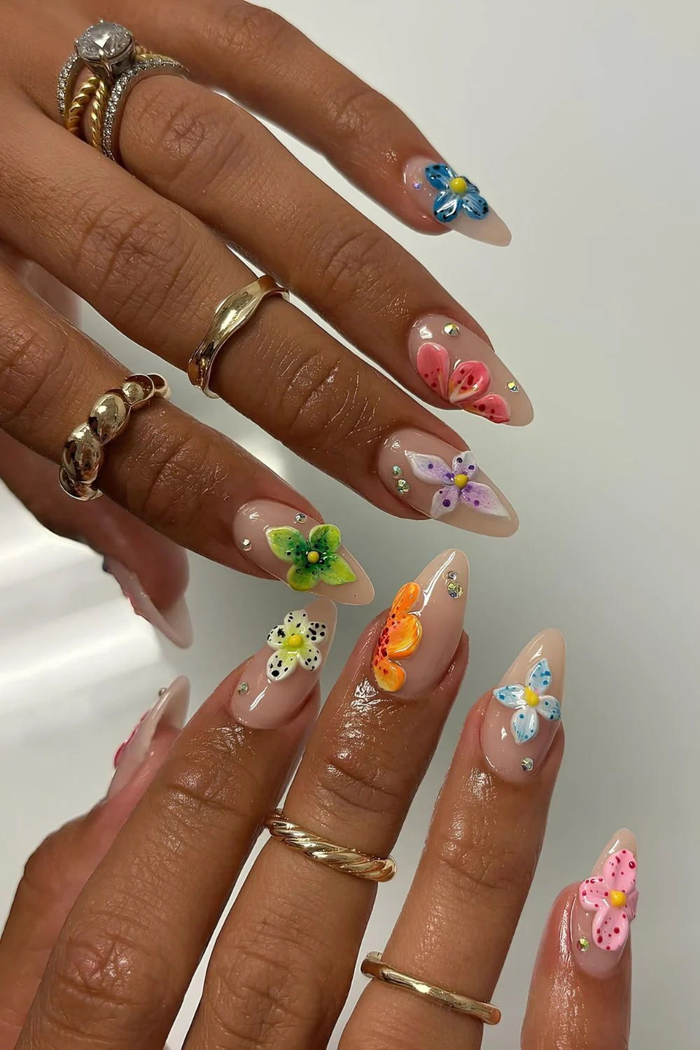 Milky nails with colorful sculpted flowers