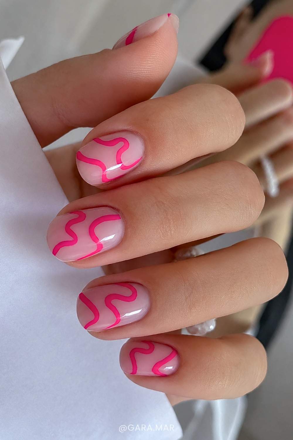 Milky nails with freeform pink swirls