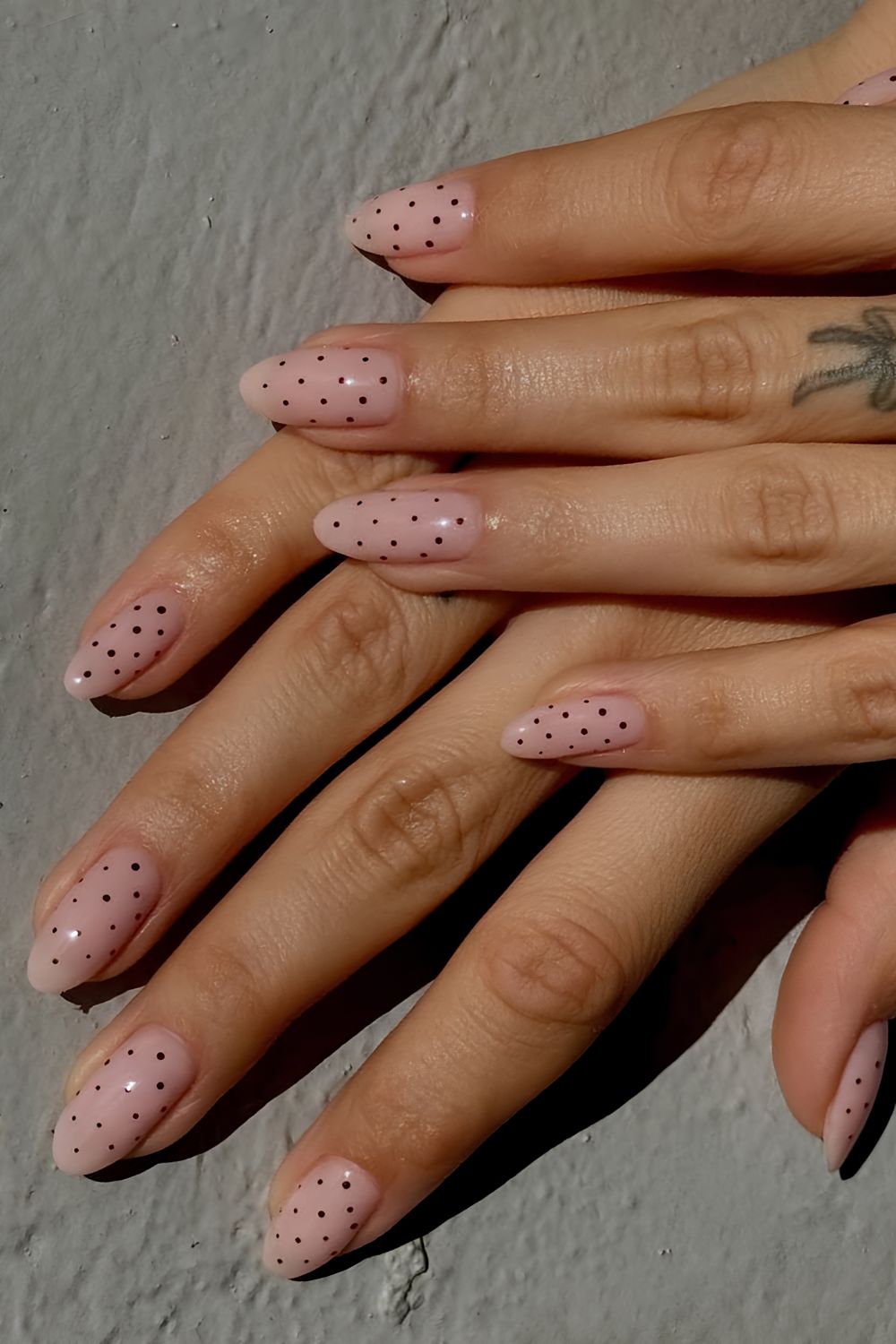Milky pink nails with black micro dots