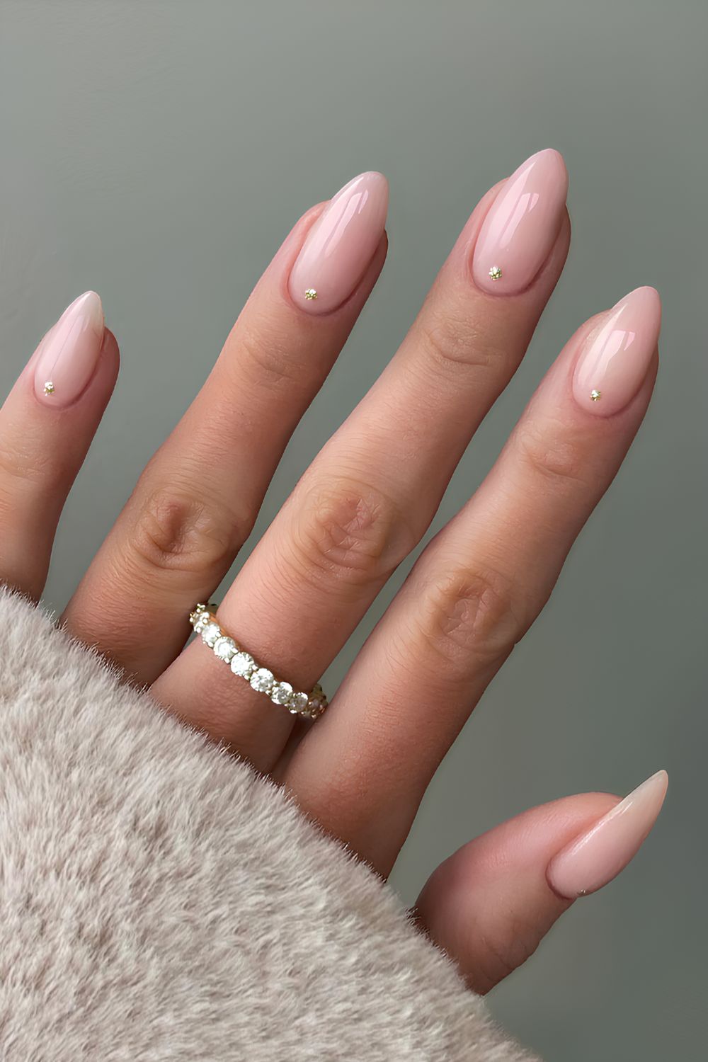 Milky pink nails with glittery dot accents