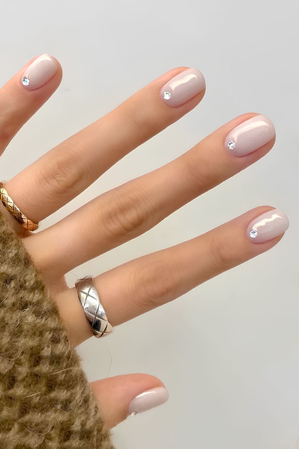 Milky white mani with cuticle rhinestones