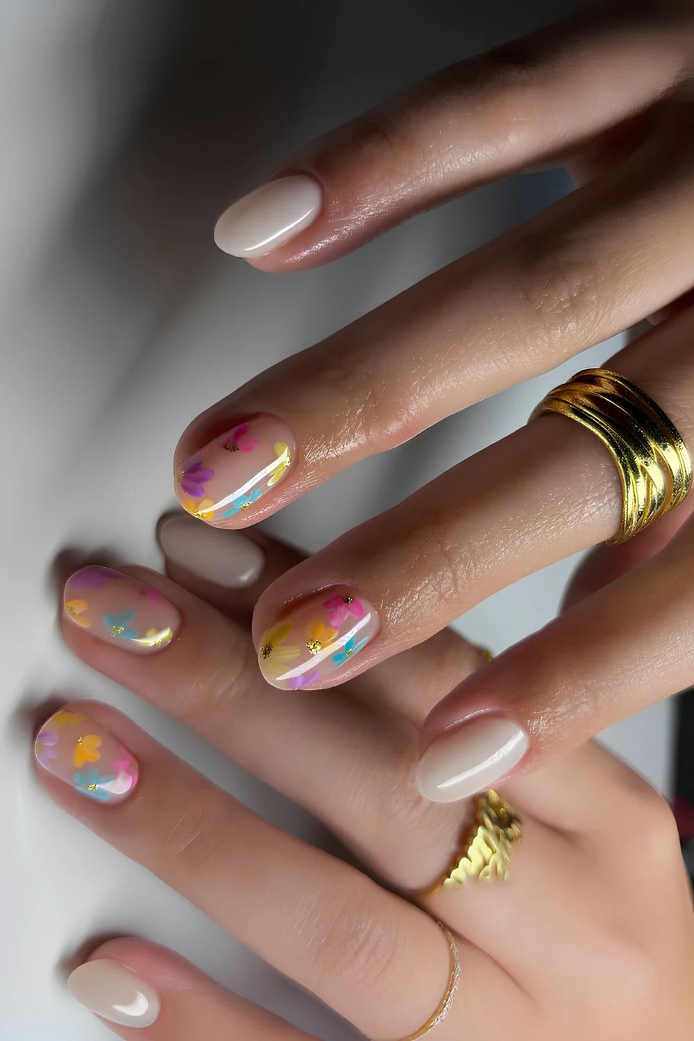 Milky white nails with colorful floral art