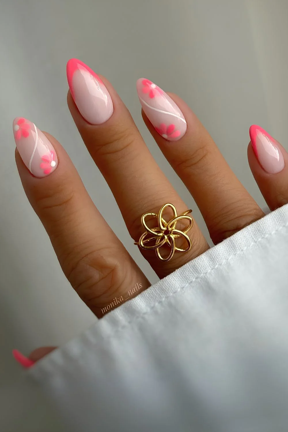 Neon pink French nails with flowers and swirls