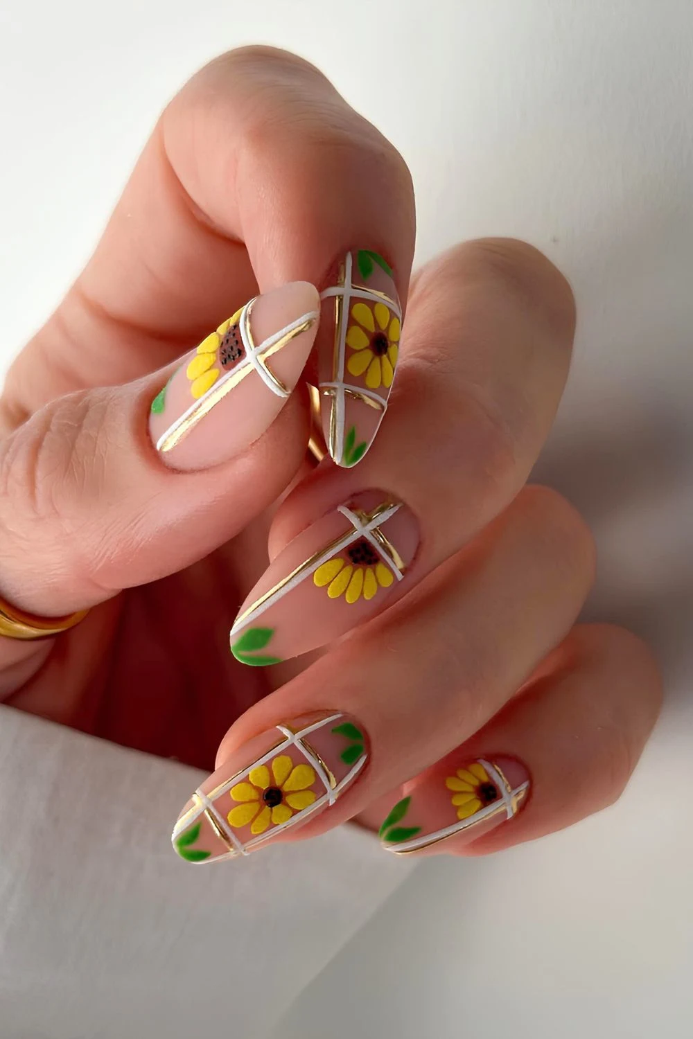Neutral matte nails with sunflowers and stripes