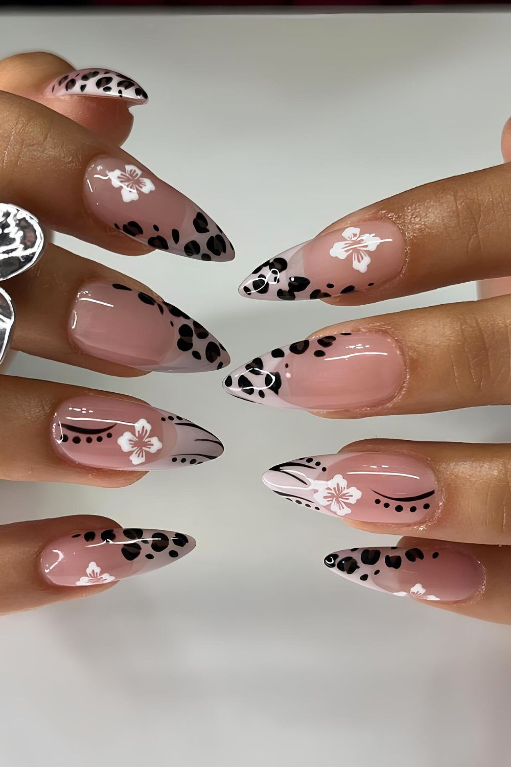Neutral nails with animal print and white hibiscus flowers