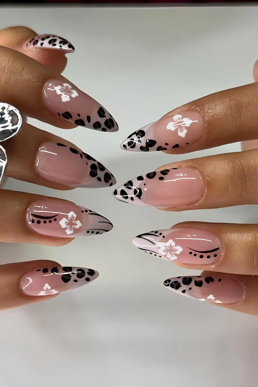 Neutral nails with animal print and white hibiscus flowers