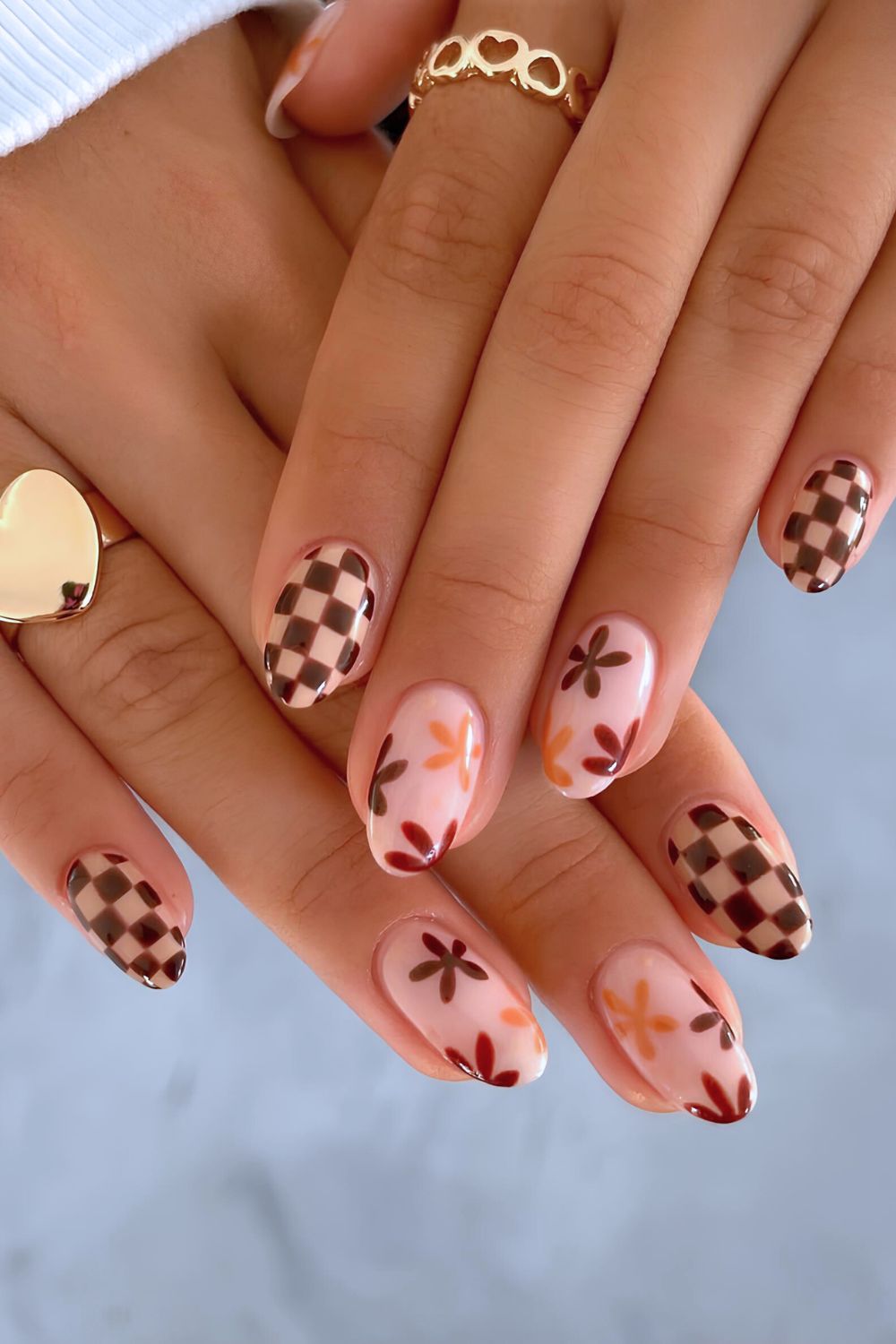 Neutral nails with brown florals and checkerboard design