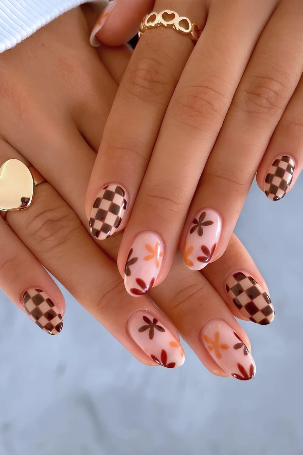 Neutral nails with brown florals and checkerboard design
