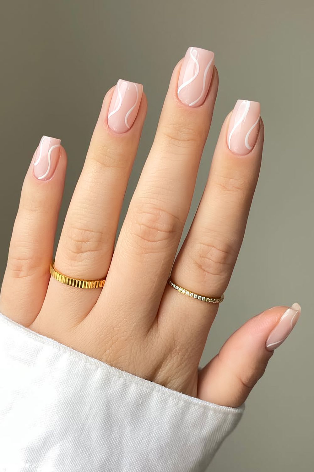 Neutral nails with white swirls