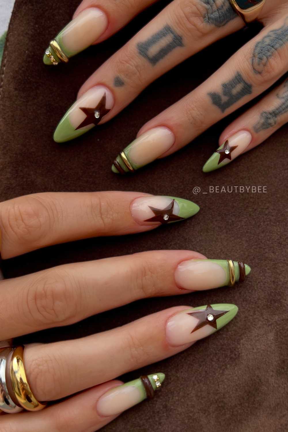 Olive French nails with brown stars and bangle art