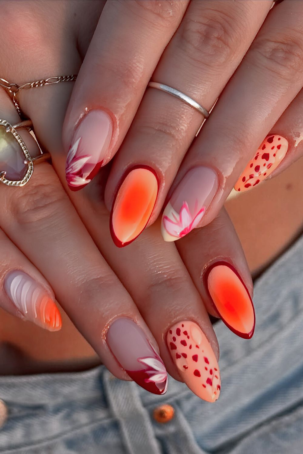 Orange and red nails with aura effect, textured details and florals