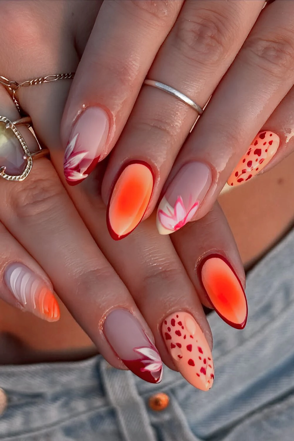 Orange and red nails with aura effect, textured details and florals