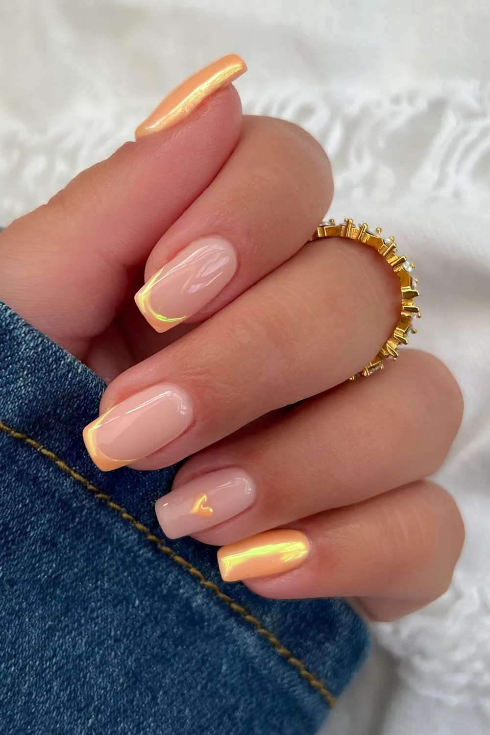 Peach chrome solid and French tip nails with heart accent