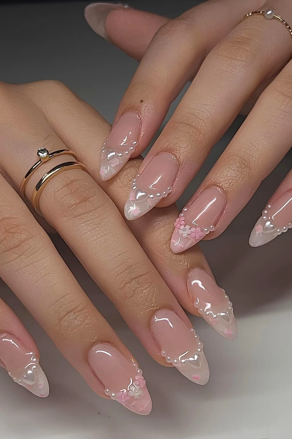 Pearly white and pink French almond tips with florals and pearls