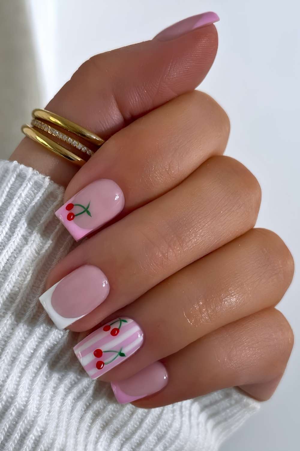 Pink and white nails with stripes and cherries