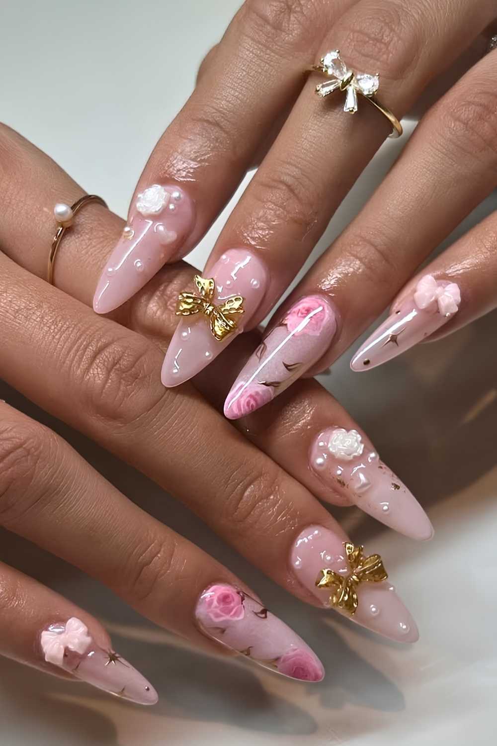 Pink nails with roses and gold bows