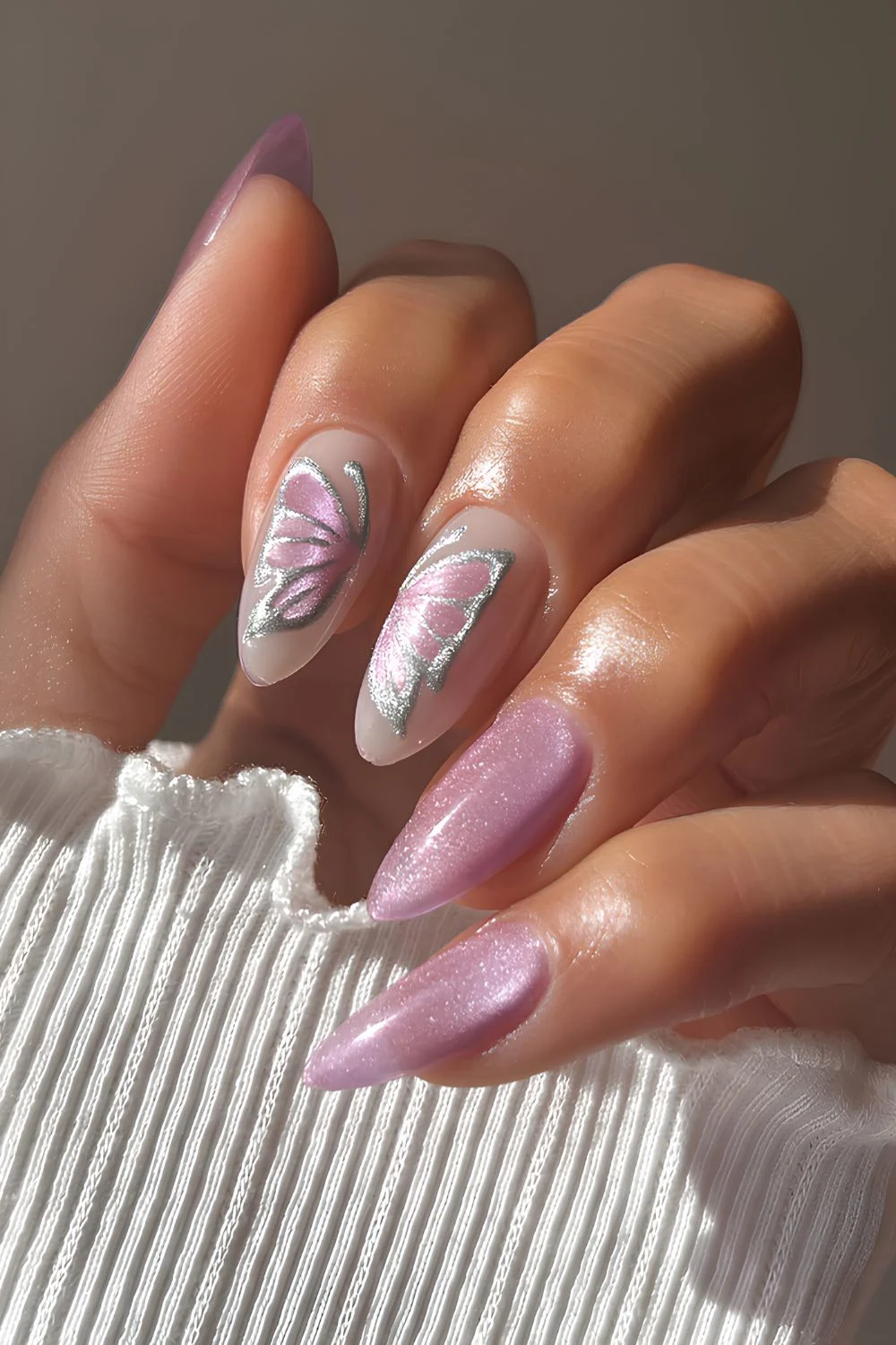 Pink velvet almond nails with butterfly wings