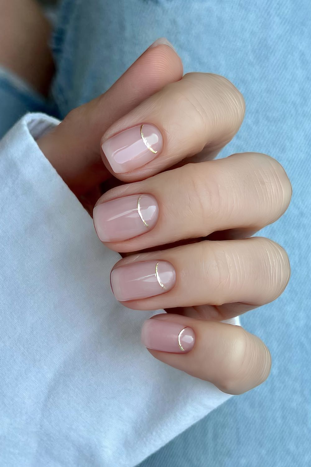 Sheer pink nails with silver chrome cuticle outline