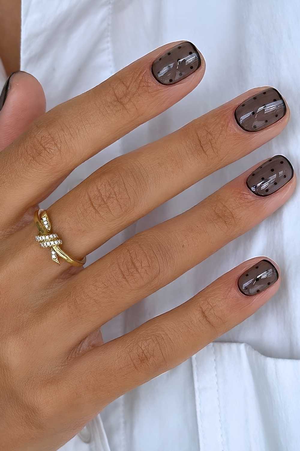Short black polka dot manicure
