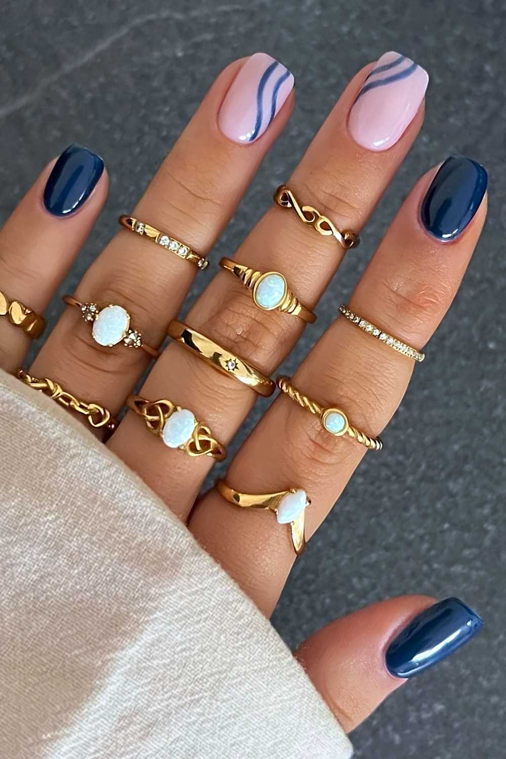 Short navy blue nails with accent line art