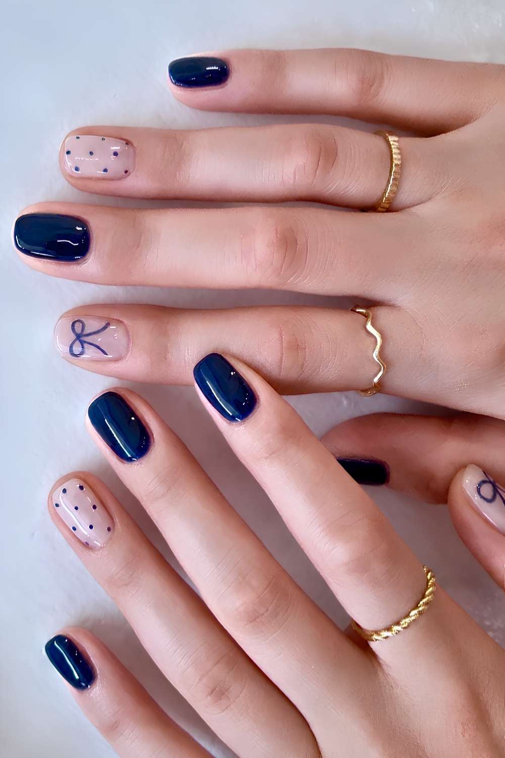 Short navy nails with polka dots and bows