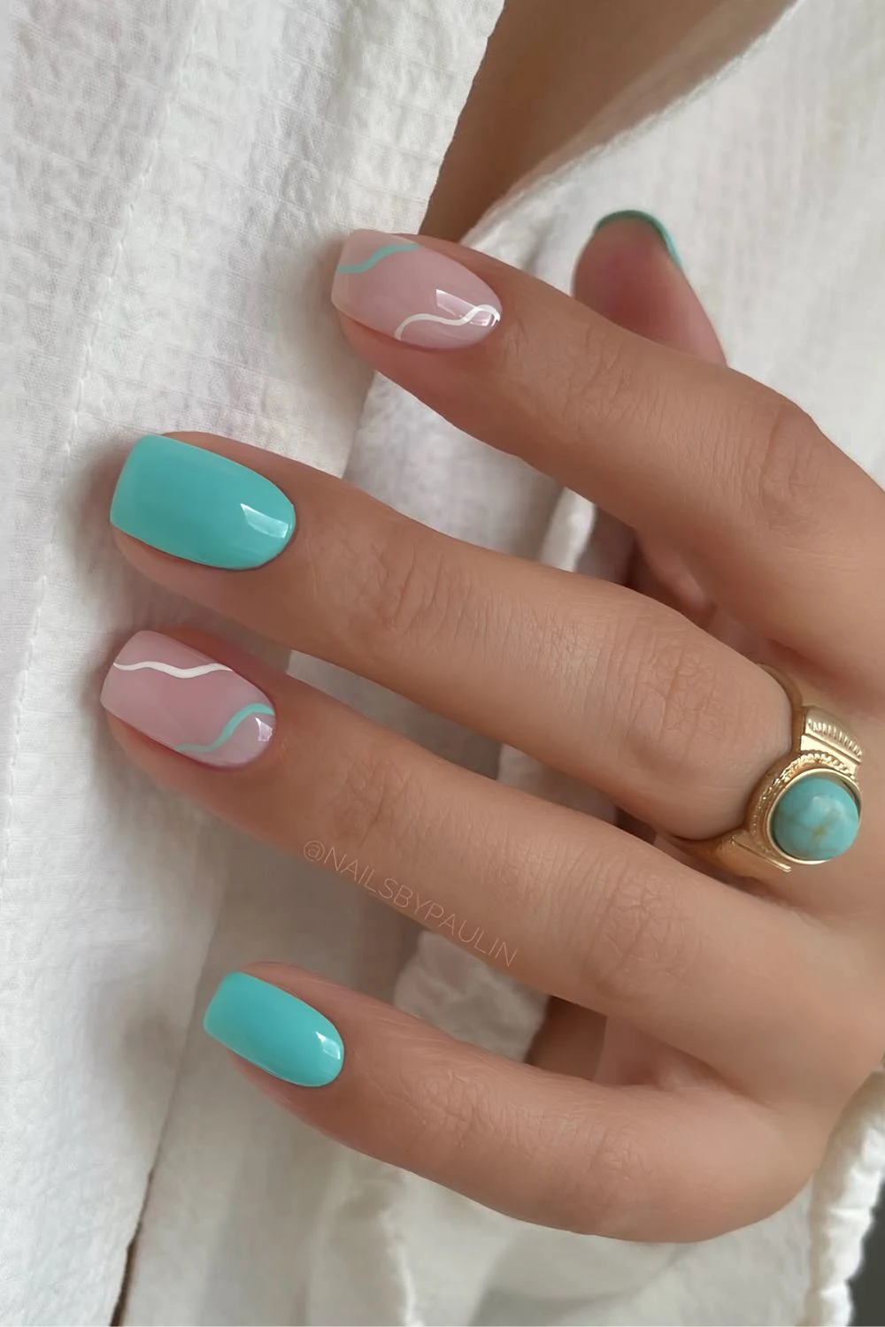 Turquoise and milky white nails with swirls