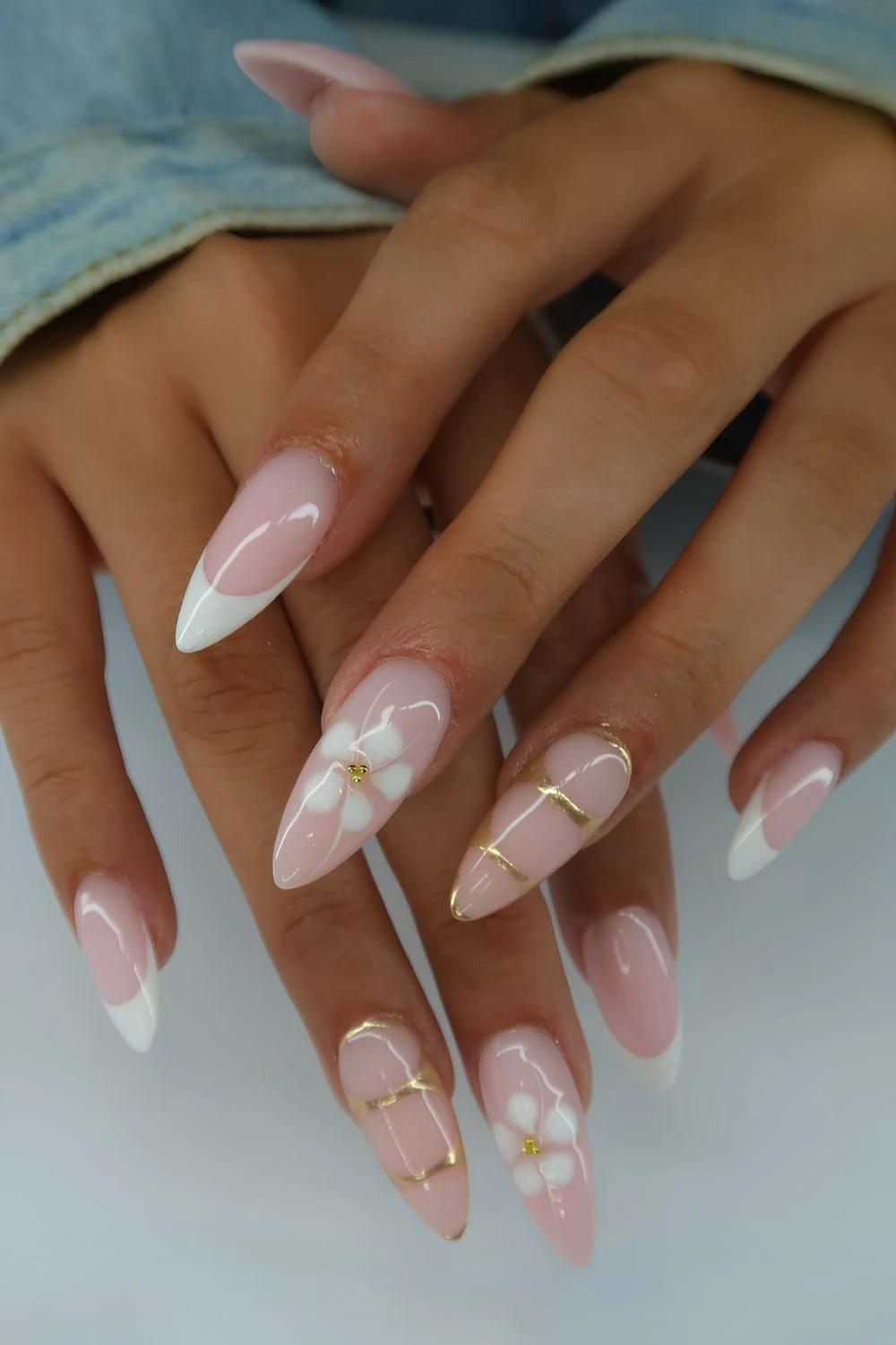 White French nails with blooming flowers and gold details