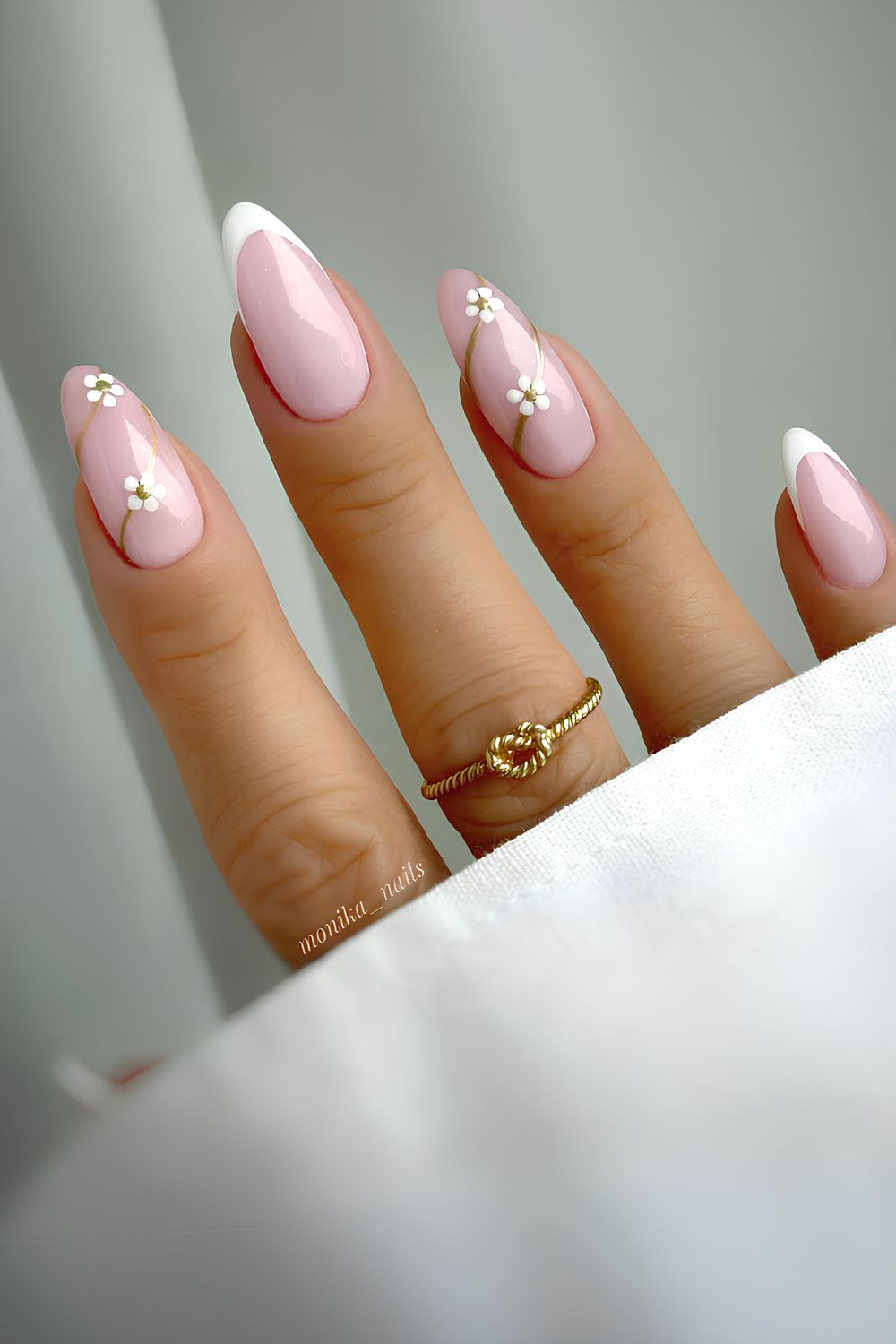 White floral French mani on a pink base